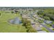 Scenic aerial view of a residential community with golf course, water features, and tree-lined streets at 10728 Moshie Ln, San Antonio, FL 33576