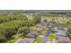 Aerial view of a residential neighborhood with lush greenery and ponds at 10728 Moshie Ln, San Antonio, FL 33576