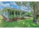 Spacious backyard featuring a sunroom and beautiful landscaping at 10728 Moshie Ln, San Antonio, FL 33576