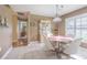 Cozy dining room with lots of natural light and a display cabinet at 10728 Moshie Ln, San Antonio, FL 33576