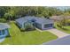 Well-maintained single-Gathering home with lush landscaping and a screened garage at 10728 Moshie Ln, San Antonio, FL 33576