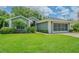 Charming single-story home with well-manicured lawn, brick driveway, and a screened-in two car garage at 10728 Moshie Ln, San Antonio, FL 33576