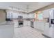 Well-lit kitchen featuring white cabinets, stainless appliances, and center island at 10728 Moshie Ln, San Antonio, FL 33576