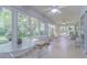 Bright sunroom filled with natural light and comfortable seating area at 10728 Moshie Ln, San Antonio, FL 33576