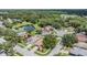 Aerial view of a neighborhood with houses, mature trees, and a scenic lake at 11022 Connacht Way, Tampa, FL 33610