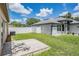 Spacious backyard featuring a well-maintained lawn, white fence, and concrete patio area perfect for outdoor living at 11022 Connacht Way, Tampa, FL 33610