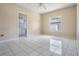 Bright bedroom with tile floors, ceiling fan and window view to the backyard at 11022 Connacht Way, Tampa, FL 33610