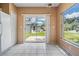 Dining area features sliding glass door to back and a window with views of back and side yards at 11022 Connacht Way, Tampa, FL 33610