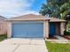 A home with a two-car garage and well-maintained lawn at 11022 Connacht Way, Tampa, FL 33610