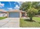 Charming single Gathering home with a two-car garage, well-kept lawn, and mature landscaping at 11022 Connacht Way, Tampa, FL 33610