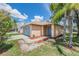 Charming single-story home with a light blue front door, attached garage, and a well-maintained front yard at 11022 Connacht Way, Tampa, FL 33610