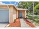 Charming front entrance with a walkway lined with mulch and a muted blue front door at 11022 Connacht Way, Tampa, FL 33610
