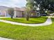 Corner lot home featuring a well-maintained lawn and tidy landscaping at 11022 Connacht Way, Tampa, FL 33610