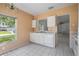 Sunny kitchen area featuring white appliances, tile floor and cabinets and a view of the yard at 11022 Connacht Way, Tampa, FL 33610