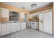 Well-equipped kitchen featuring white cabinetry, appliances, and a practical design for easy meal preparation at 11022 Connacht Way, Tampa, FL 33610