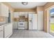 Efficient kitchen with white appliances, plenty of storage, and a convenient layout for cooking at 11022 Connacht Way, Tampa, FL 33610
