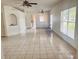 Bright living room with tile floors, ceiling fans, and abundant natural light through the windows at 11022 Connacht Way, Tampa, FL 33610