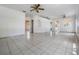 Open-concept living room with tile flooring, ceiling fans, and abundant natural light at 11022 Connacht Way, Tampa, FL 33610