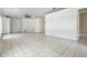 Spacious living room with tile flooring, ceiling fan, and neutral paint, creating a bright and airy atmosphere at 11022 Connacht Way, Tampa, FL 33610