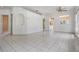 Open living space with tile floors, decorative niche, and view to the kitchen at 11022 Connacht Way, Tampa, FL 33610