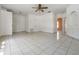 Spacious living area with tile floors, ceiling fan, and multiple entryways at 11022 Connacht Way, Tampa, FL 33610