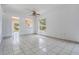 Open living area with tile floors, natural light, and view of the outdoors at 11022 Connacht Way, Tampa, FL 33610