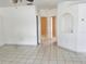 Bright living room featuring neutral tile flooring, white walls, and an arched wall nook, providing a clean and airy atmosphere at 11022 Connacht Way, Tampa, FL 33610