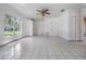 Living room featuring tile floors, ceiling fan, and a large window with a street view at 11022 Connacht Way, Tampa, FL 33610