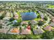 Aerial view showcasing the home's setting within a lakeside community at 1112 Mcdaniel St # 78, Sun City Center, FL 33573