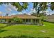 A serene backyard with lush green grass and tropical palm trees at 1112 Mcdaniel St # 78, Sun City Center, FL 33573