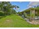 A beautifully landscaped backyard featuring lush green grass and mature trees at 1112 Mcdaniel St # 78, Sun City Center, FL 33573