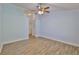 Bright bedroom featuring wood-look floors, a closet, and doorway to another room at 1112 Mcdaniel St # 78, Sun City Center, FL 33573