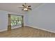 Bright bedroom features wood-look floors, white trim, and a view to the yard at 1112 Mcdaniel St # 78, Sun City Center, FL 33573