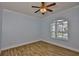 Bright bedroom features wood-look floors, white trim, and a view to the yard at 1112 Mcdaniel St # 78, Sun City Center, FL 33573