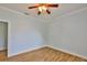 Bright bedroom featuring wood-look floors and white trim at 1112 Mcdaniel St # 78, Sun City Center, FL 33573