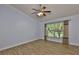 Bright bedroom features wood-look floors, white trim, and a view to the yard at 1112 Mcdaniel St # 78, Sun City Center, FL 33573