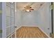 Bedroom featuring wood-look flooring, ceiling fan, crown molding and natural light through french doors at 1112 Mcdaniel St # 78, Sun City Center, FL 33573