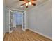 Bright bedroom featuring wood-look floors, white trim and French doors to another room at 1112 Mcdaniel St # 78, Sun City Center, FL 33573