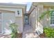 A welcoming walkway leads to the front door, framed by lush greenery and tasteful exterior details at 1112 Mcdaniel St # 78, Sun City Center, FL 33573