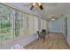 Bright sunroom with wood-look flooring, multiple windows, and natural light at 1112 Mcdaniel St # 78, Sun City Center, FL 33573