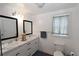 Bright bathroom featuring double vanity, marble countertop, and modern fixtures at 13637 13Th St, Dade City, FL 33525