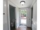 Cozy half bath with a modern toilet and a door that leads to the outdoor area at 13637 13Th St, Dade City, FL 33525