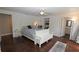 Bright bedroom with hardwood floors, white trim, ensuite bath, and sitting area at 13637 13Th St, Dade City, FL 33525
