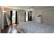 Bedroom featuring hardwood floors, white walls, a ceiling fan, and two large closets at 13637 13Th St, Dade City, FL 33525