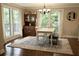 Bright dining room with large windows, chandelier, area rug, and stylish wood furniture at 13637 13Th St, Dade City, FL 33525