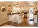Open kitchen with island seating, stainless appliances and view to the outdoor space at 13637 13Th St, Dade City, FL 33525