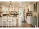 Spacious kitchen featuring white cabinets, stainless appliances, hardwood floors and a large letter M at 13637 13Th St, Dade City, FL 33525