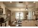 Open kitchen view with modern appliances, white cabinets, dining area and wood look floors at 13637 13Th St, Dade City, FL 33525