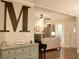 Living room features neutral walls, hardwood floors, cabinet and decoratives, and views to a seating area at 13637 13Th St, Dade City, FL 33525