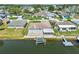A waterfront home offers a boat lift, screened in lanai, and lush yard at 13909 Berkowitz Ave, Hudson, FL 34667